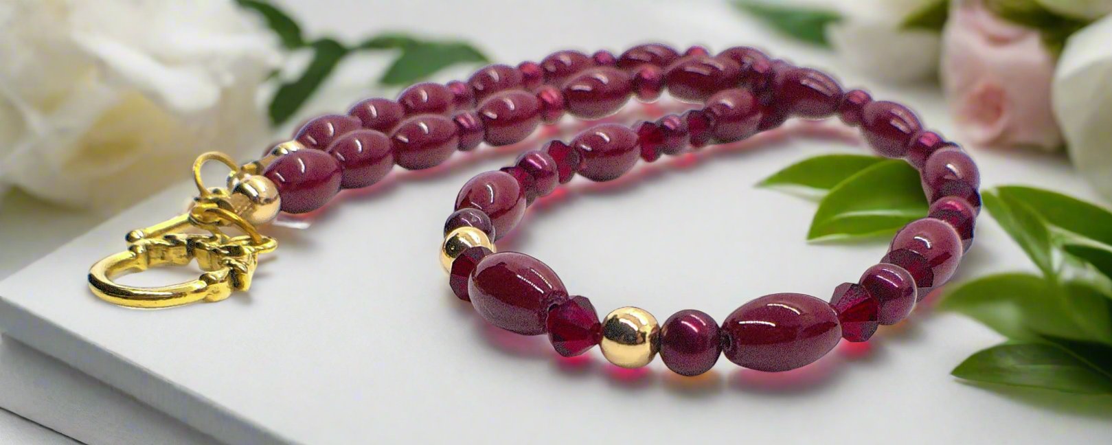https://www.artistryjewelry.net/products/lovely-burgundy-surprise-necklace