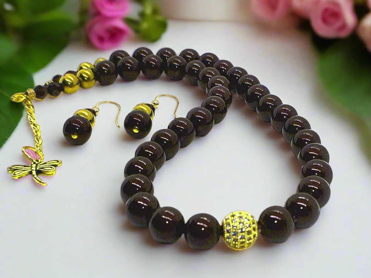 This is an exquisite brown necklace set.  Perfect for any occasion or for a special gift.  Made with Swarvoski Mocca crystals, Swarvoski Pearl Beads, Micro Pave CZ ball.  The earrings have Gold Filled ear hooks.  This set is simply stunning for anyone.
