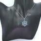 https://www.artistryjewelry.net/products/lovely-blue-winter-snowflake-necklace