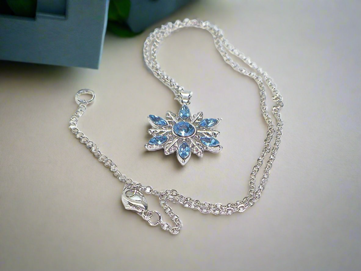 https://www.artistryjewelry.net/products/lovely-blue-winter-snowflake-necklace