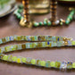 https://www.artistryjewelry.net/products/charming-green-and-gold-beaded-necklace-by-artistry-jewelry