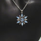 https://www.artistryjewelry.net/products/lovely-blue-winter-snowflake-necklace