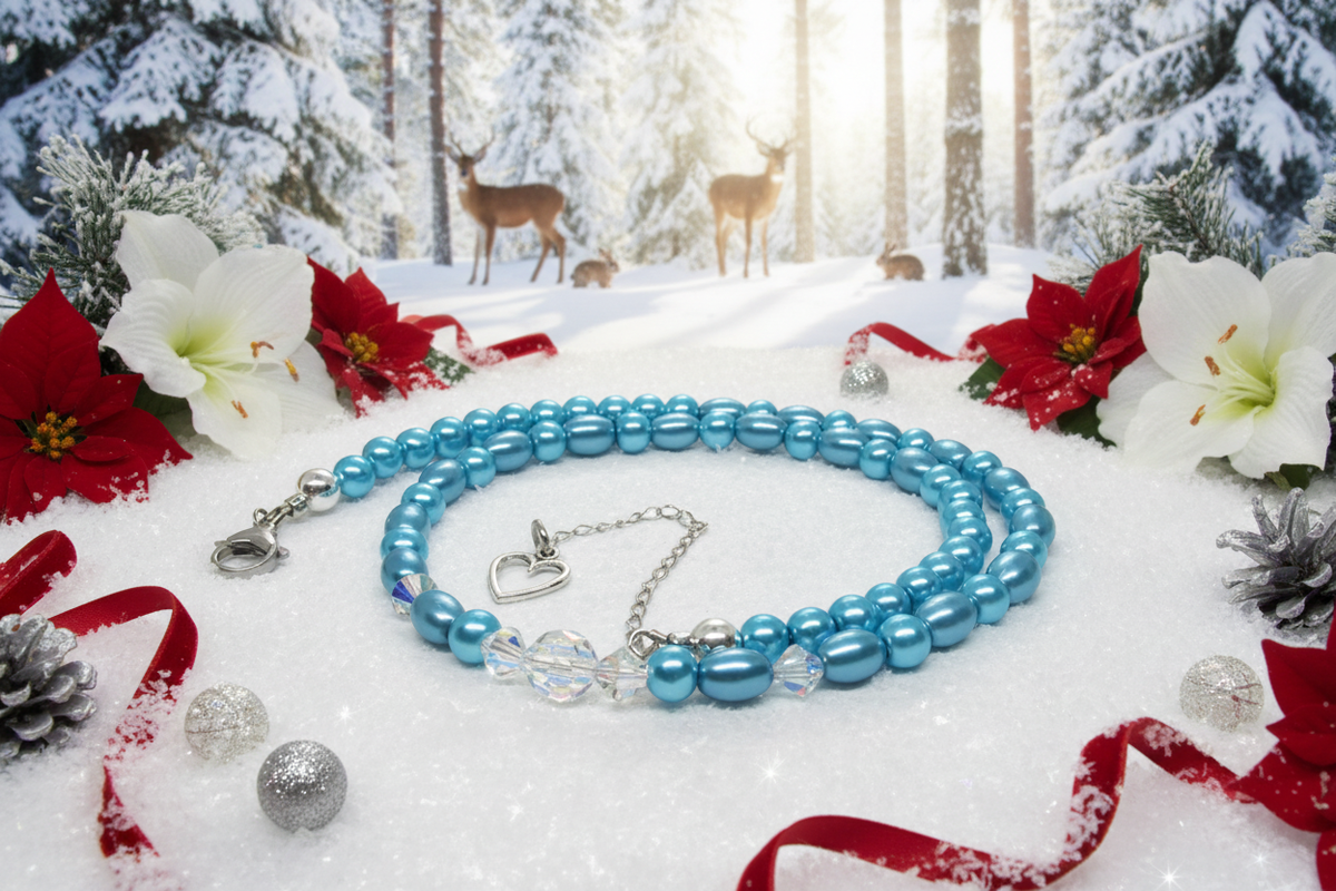 Light-blue necklace lying on sparkling snow in a Christmas forest