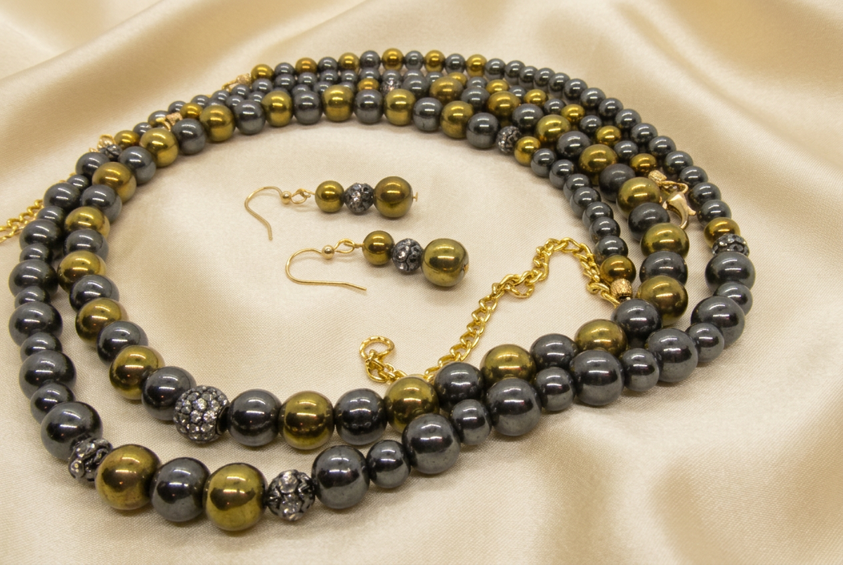Original jewelry reference with soft gold satin background
