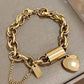 https://www.artistryjewelry.net/products/exciting-puffy-gold-heart-charm-chain-bracelet